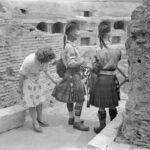 This Italian woman is curiously inspecting the kilt of a Scottish soldier. The soldiers are standing near the Coliseum after the liberation of Rome in 1944.